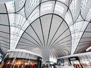 Modern architectural design with curved ceilings in a retail space in Daxing District, Beijing.